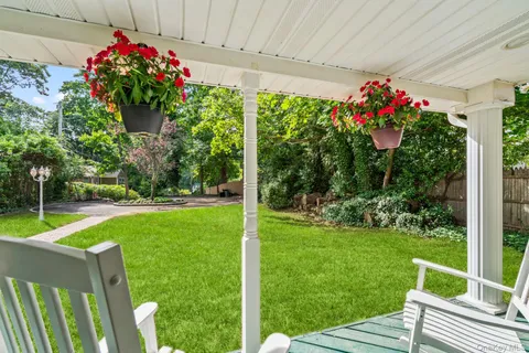 a house view with a sitting space and garden space