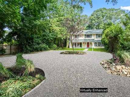 a view of a house with a yard and potted plants