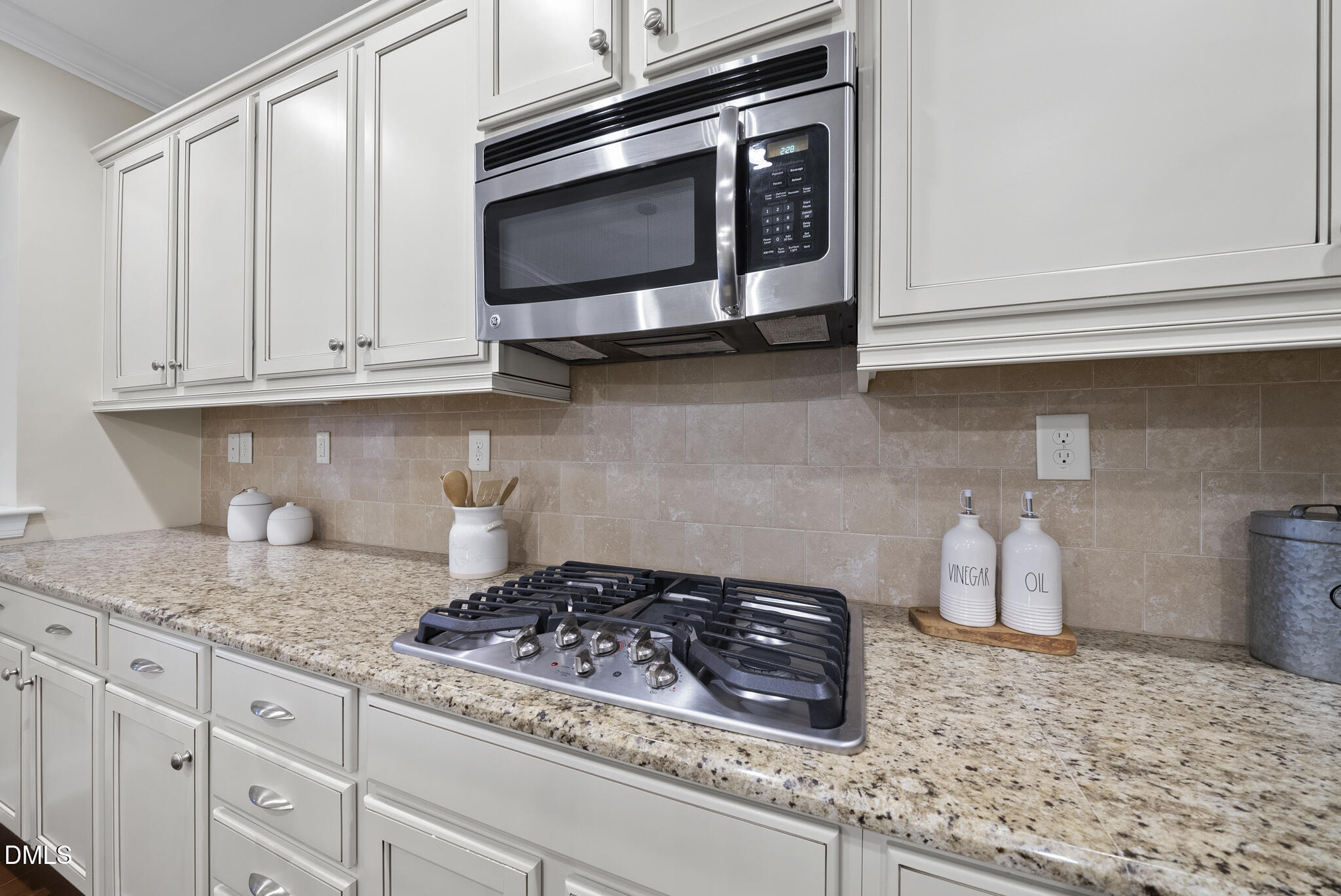 765 Fallon Grove Way Raleigh, NC 27608 - Photo 14 of 43 a kitchen with granite countertop white cabinets and appliances