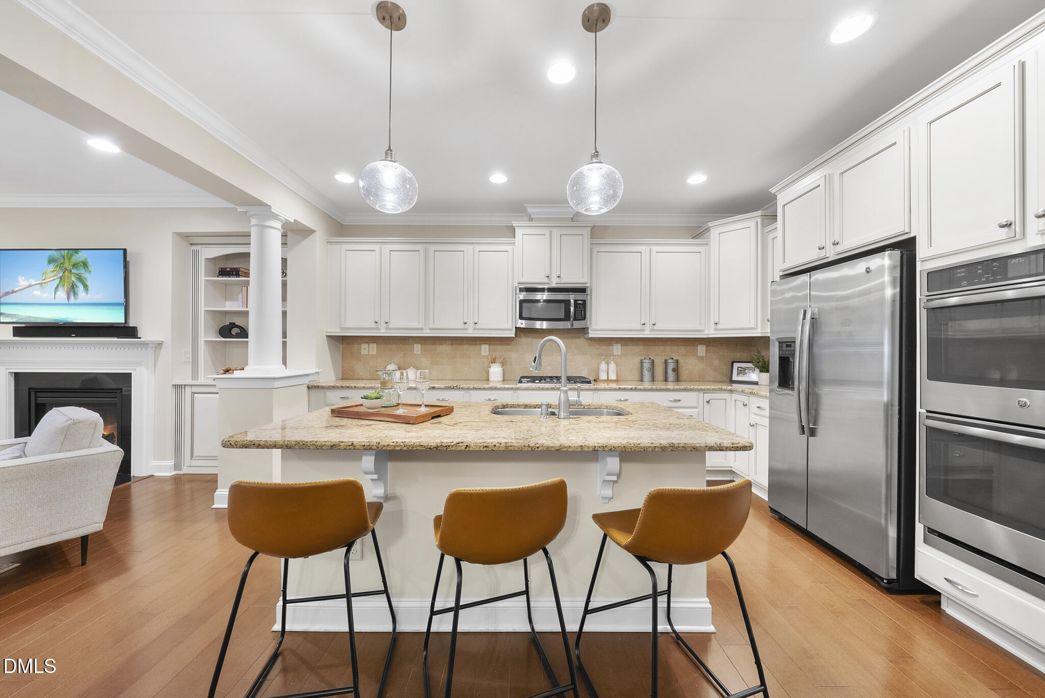 765 Fallon Grove Way Raleigh, NC 27608 - Photo 15 of 43 a kitchen with stainless steel appliances kitchen island granite countertop a dining table chairs refrigerator and microwave