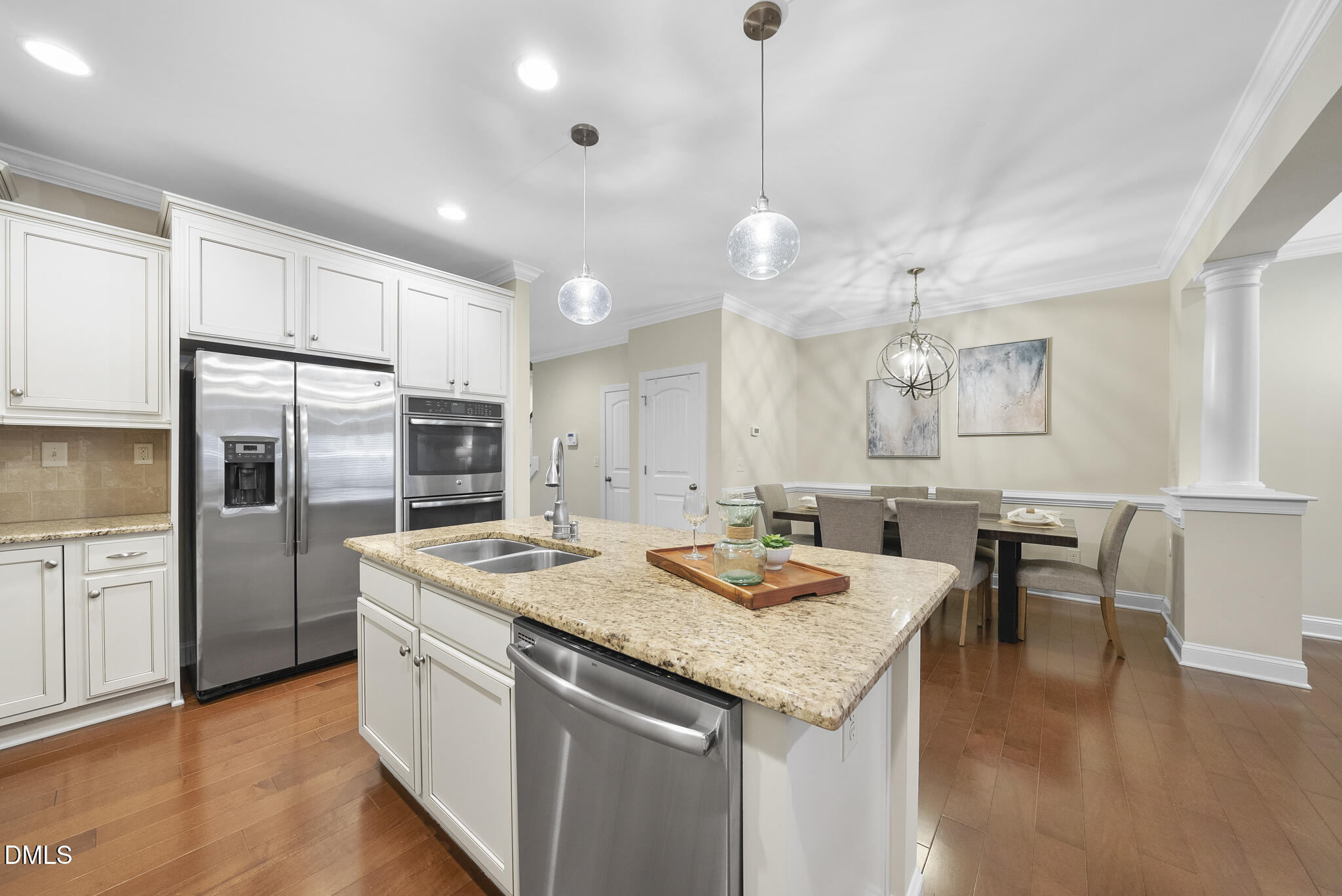 765 Fallon Grove Way Raleigh, NC 27608 - Photo 16 of 43 a kitchen with granite countertop kitchen island stainless steel appliances a sink stove and refrigerator