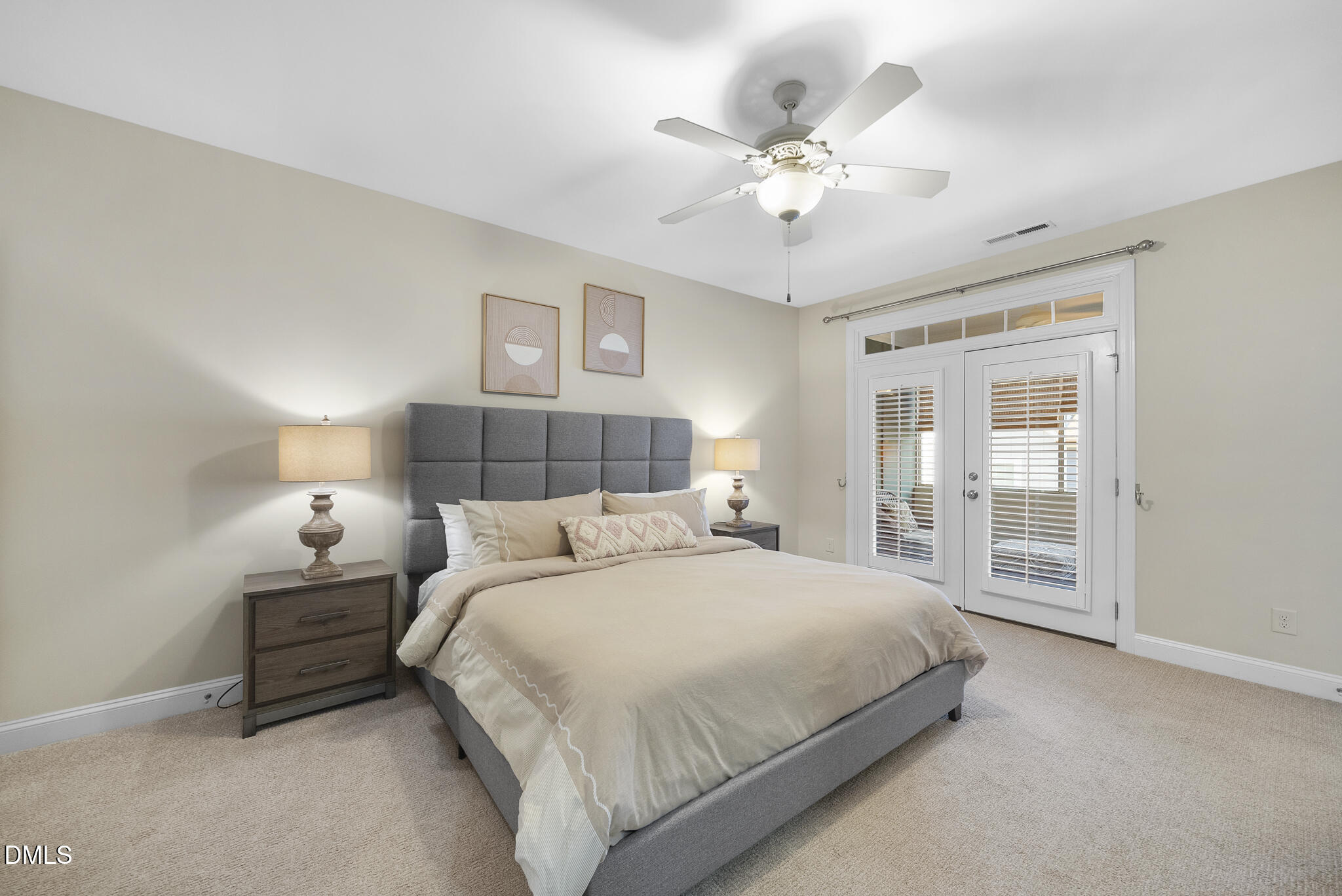 765 Fallon Grove Way Raleigh, NC 27608 - Photo 21 of 43 a bedroom with a large bed and a chandelier