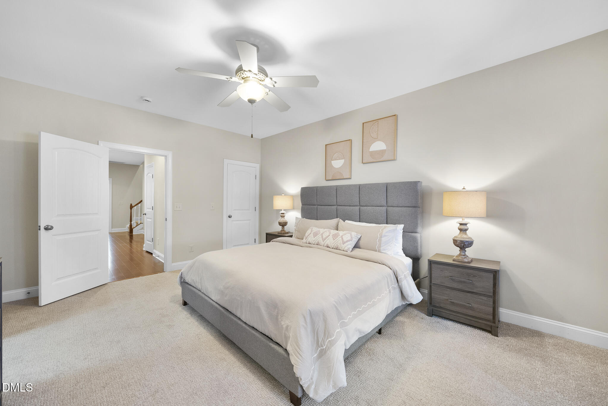765 Fallon Grove Way Raleigh, NC 27608 - Photo 22 of 43 a bedroom with a bed and a chandelier