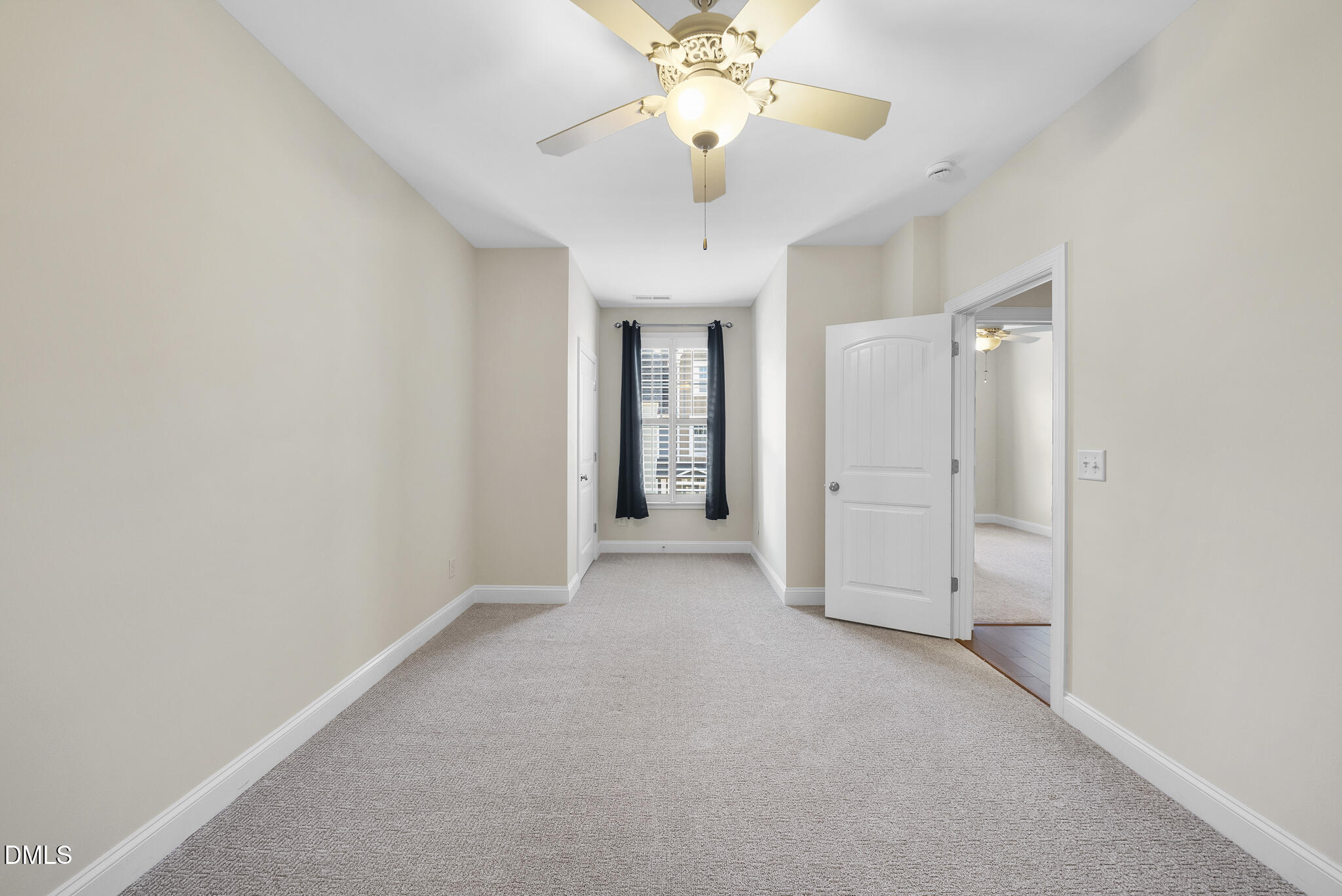 765 Fallon Grove Way Raleigh, NC 27608 - Photo 28 of 43 an empty room with a chandelier fan and a bathroom