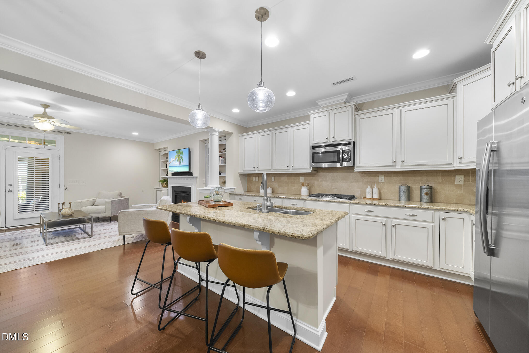 765 Fallon Grove Way Raleigh, NC 27608 - Photo 3 of 43 a kitchen with stainless steel appliances granite countertop a stove top oven a sink dishwasher a dining table and chairs with wooden floor