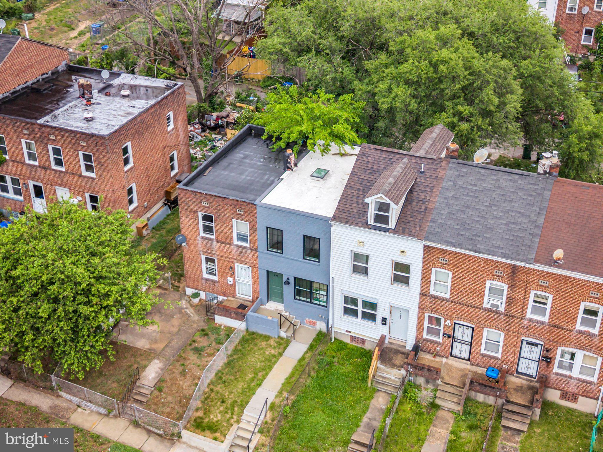 2731 Round Road Baltimore, MD 21225 - Photo 14 of 26 Charming row homes with lush greenery.