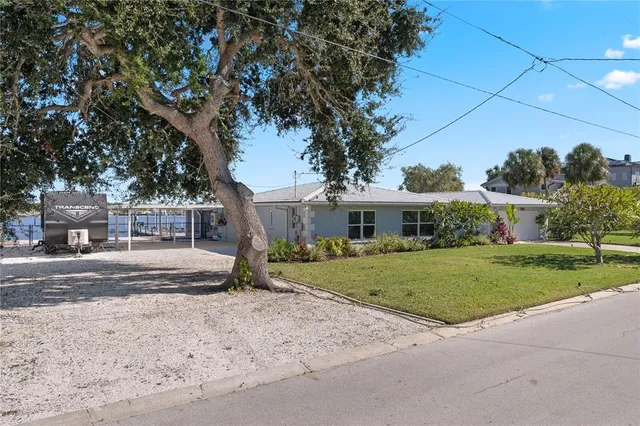a front view of a house with a yard and trees