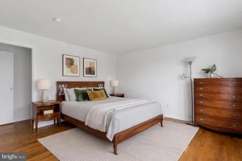 a bedroom with a bed and dresser