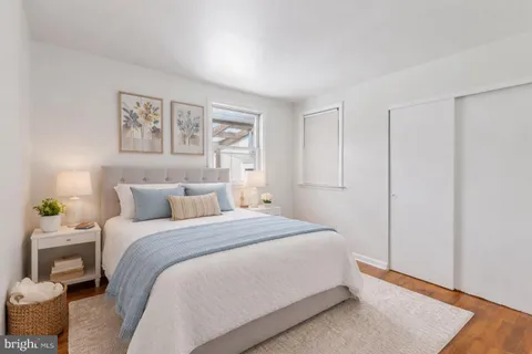 a bedroom with a bed and painting on the wall