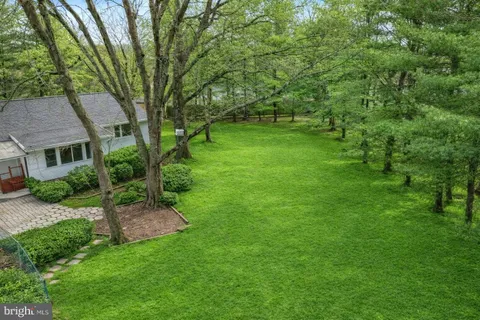 a view of backyard of house with green space