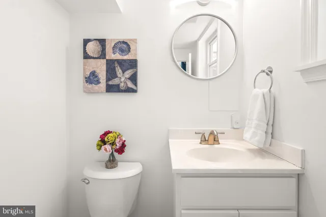 a bathroom with a sink mirror and toilet