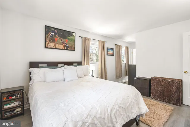 a large bed sitting in a bedroom next to a window with a bookshelf