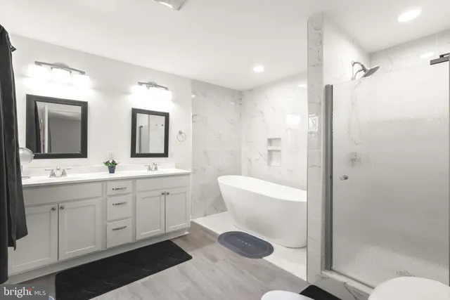 a spacious bathroom with a double vanity sink mirror and toilet