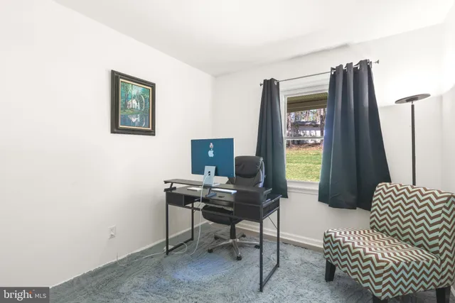 a laptop computer sitting on top of a desk and chair