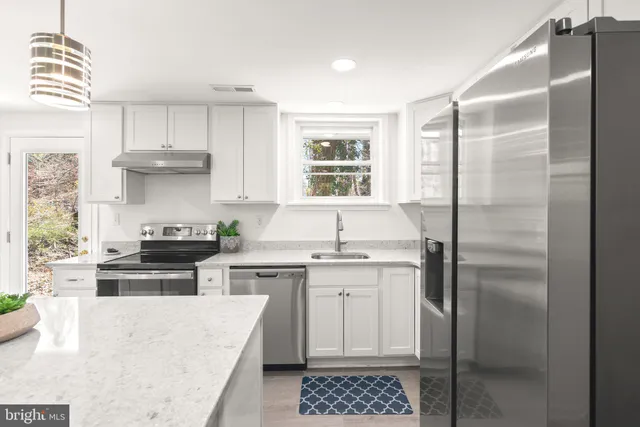 a kitchen with a stove a sink and a refrigerator