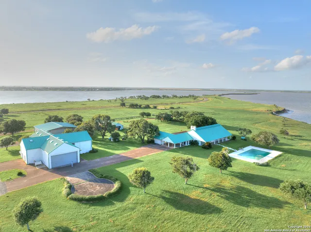 a aerial view of a house with a yard