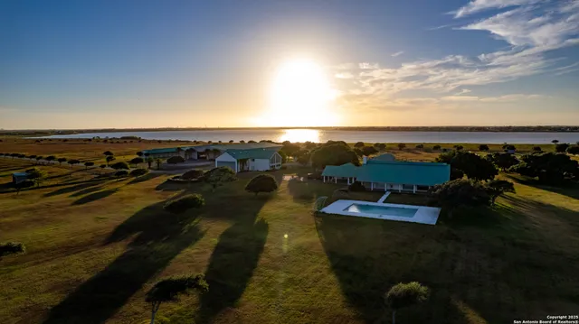 a bathroom with a granite countertop sink and a large mirror