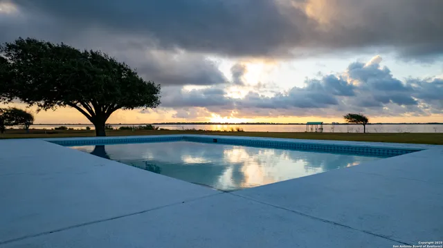 a bedroom with a bed and a lamp on table