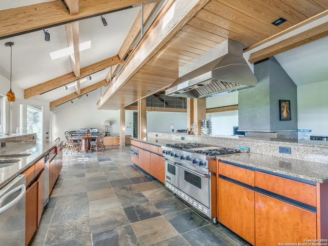 a bathroom with a granite countertop sink a mirror and shower