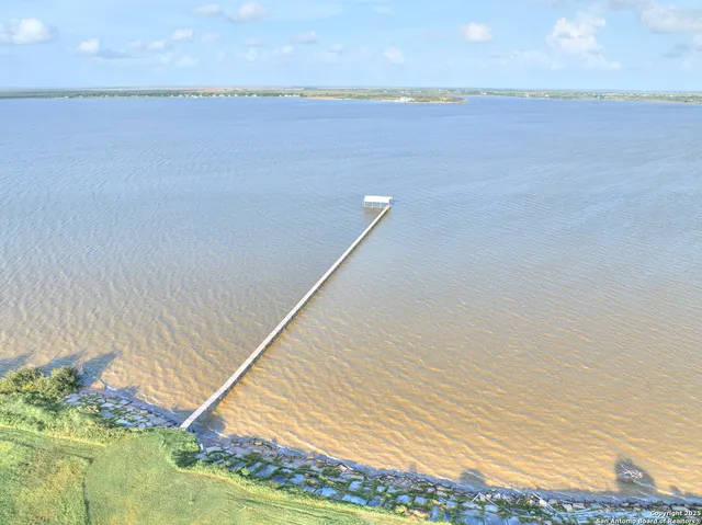 a large kitchen with kitchen island a large window a sink and stainless steel appliances