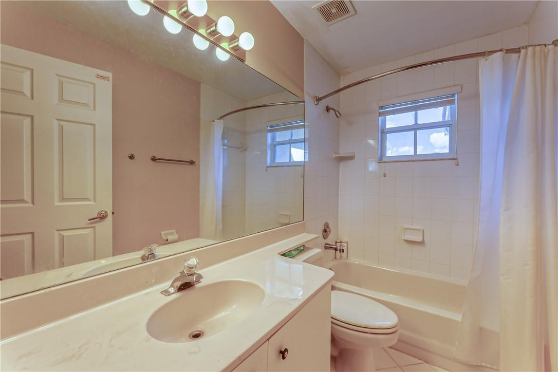 22372 Collington Drive Boca Raton, FL 33428 - Photo 19 of 22 a bathroom with a sink a toilet and shower