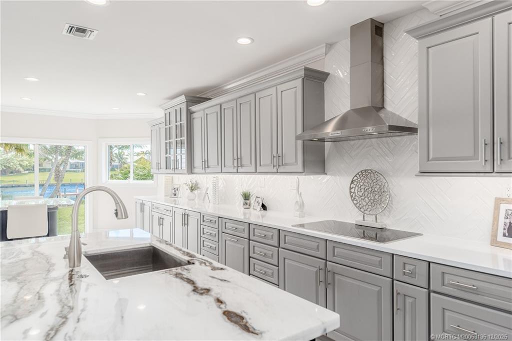 3404 Southeast Inlet Harbor Trail Stuart, FL 34996 - Photo 11 of 32 a kitchen with granite countertop a sink a stove and cabinets