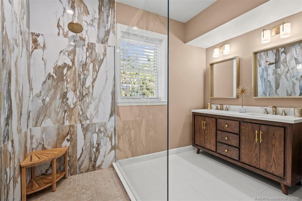 3404 Southeast Inlet Harbor Trail Stuart, FL 34996 - Photo 17 of 32 a bathroom with a double vanity sink toilet and shower