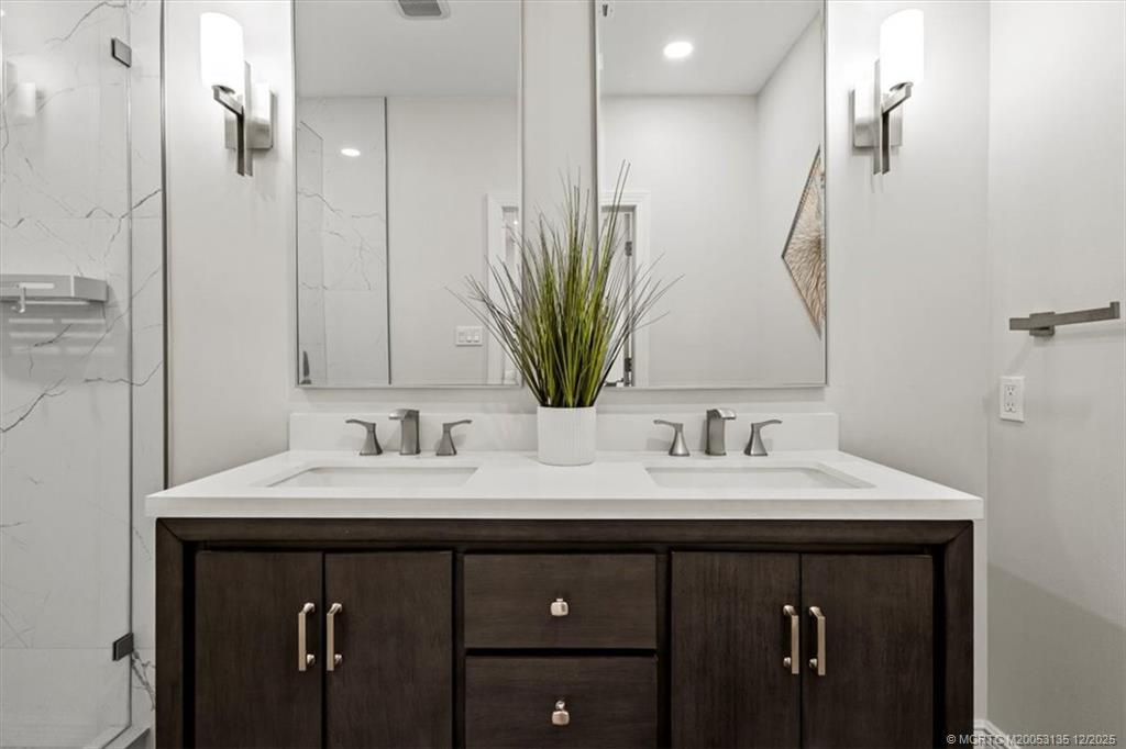 3404 Southeast Inlet Harbor Trail Stuart, FL 34996 - Photo 18 of 32 a bathroom with a double vanity sink and a mirror