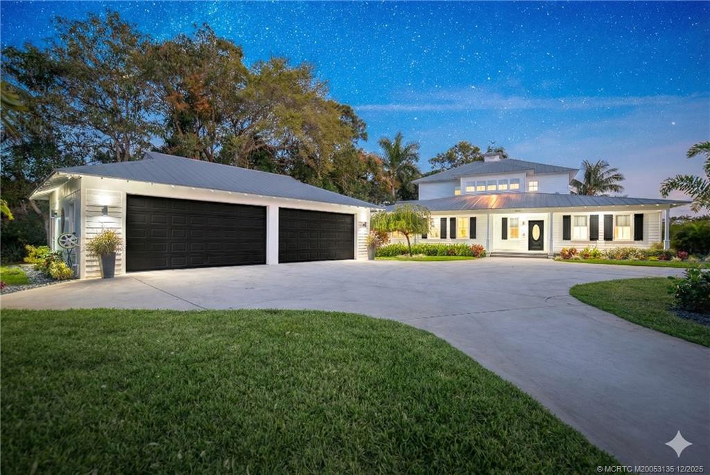 3404 Southeast Inlet Harbor Trail Stuart, FL 34996 - Photo 2 of 32 a front view of a house with a yard and garage