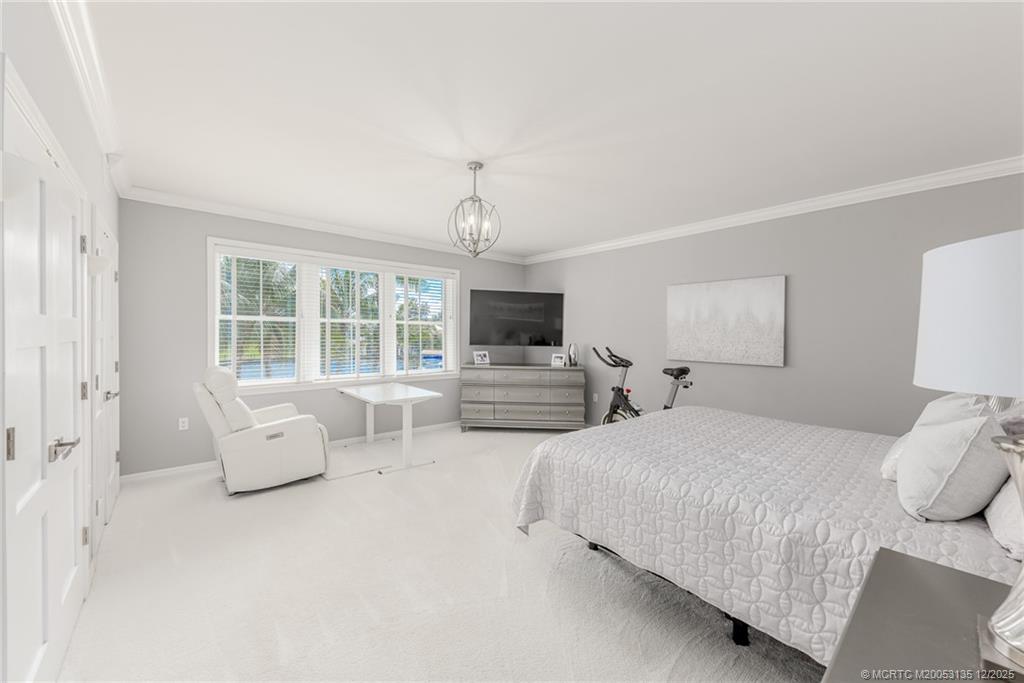 3404 Southeast Inlet Harbor Trail Stuart, FL 34996 - Photo 21 of 32 a spacious bedroom with a bed and a couch