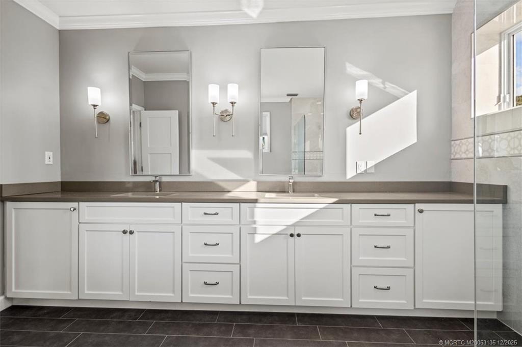 3404 Southeast Inlet Harbor Trail Stuart, FL 34996 - Photo 22 of 32 a bathroom with a sink vanity and a mirror