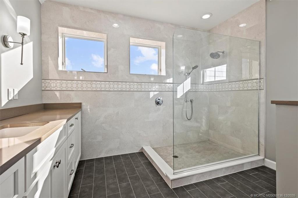 3404 Southeast Inlet Harbor Trail Stuart, FL 34996 - Photo 23 of 32 a bathroom with a shower sink and mirror