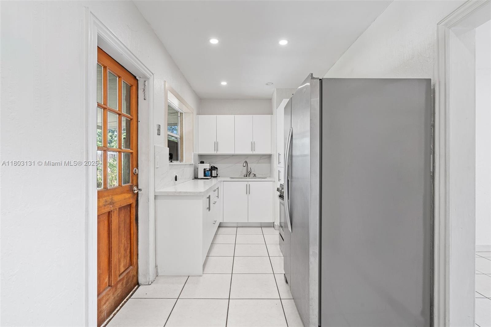 911 East 32nd Street Hialeah, FL 33013 - Photo 9 of 43 a kitchen with stainless steel appliances granite countertop a refrigerator and a stove