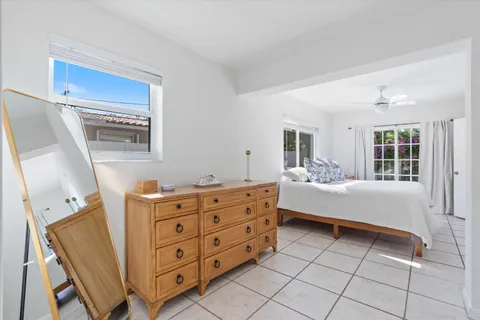 a spacious bedroom with a bed and a dresser