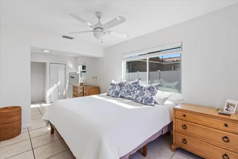 a bed room with a bed and a mirror