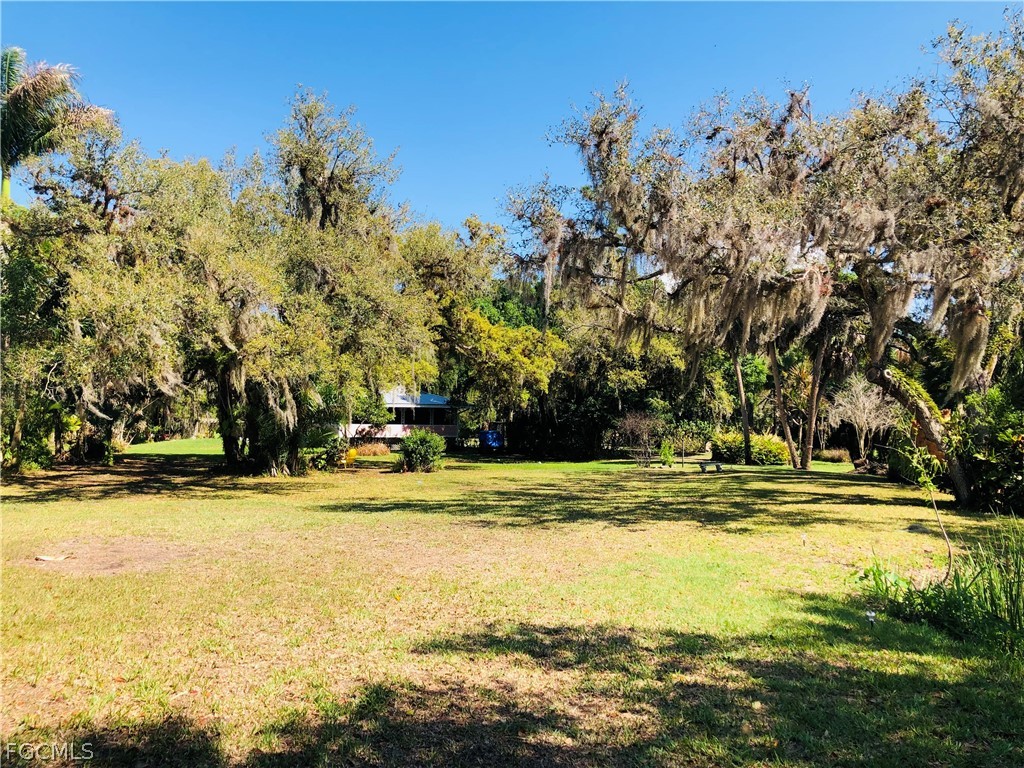 17500 Taylor Road Alva, FL 33920 - Photo 5 of 10 a view of a swimming pool with an outdoor space and seating area