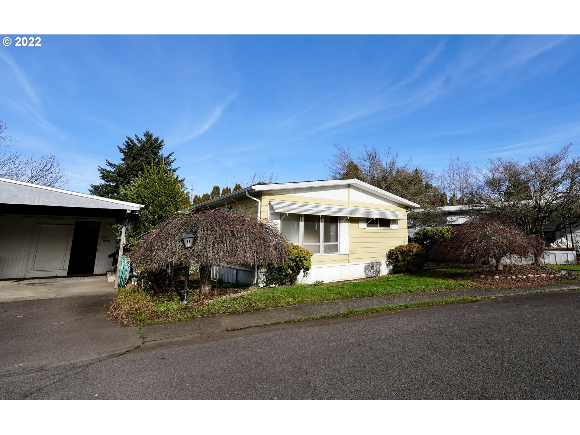 3530 Game Farm Road, Unit 11 Springfield, OR 97477 - Photo 1 of 27 a front view of a house with a yard and garage