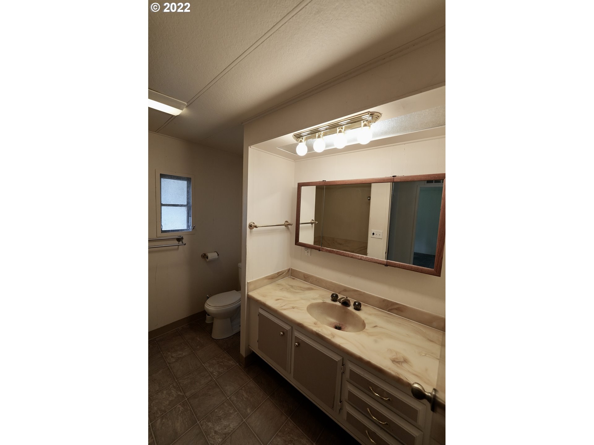 3530 Game Farm Road, Unit 11 Springfield, OR 97477 - Photo 12 of 27 a bathroom with a double vanity sink and mirror with toilet