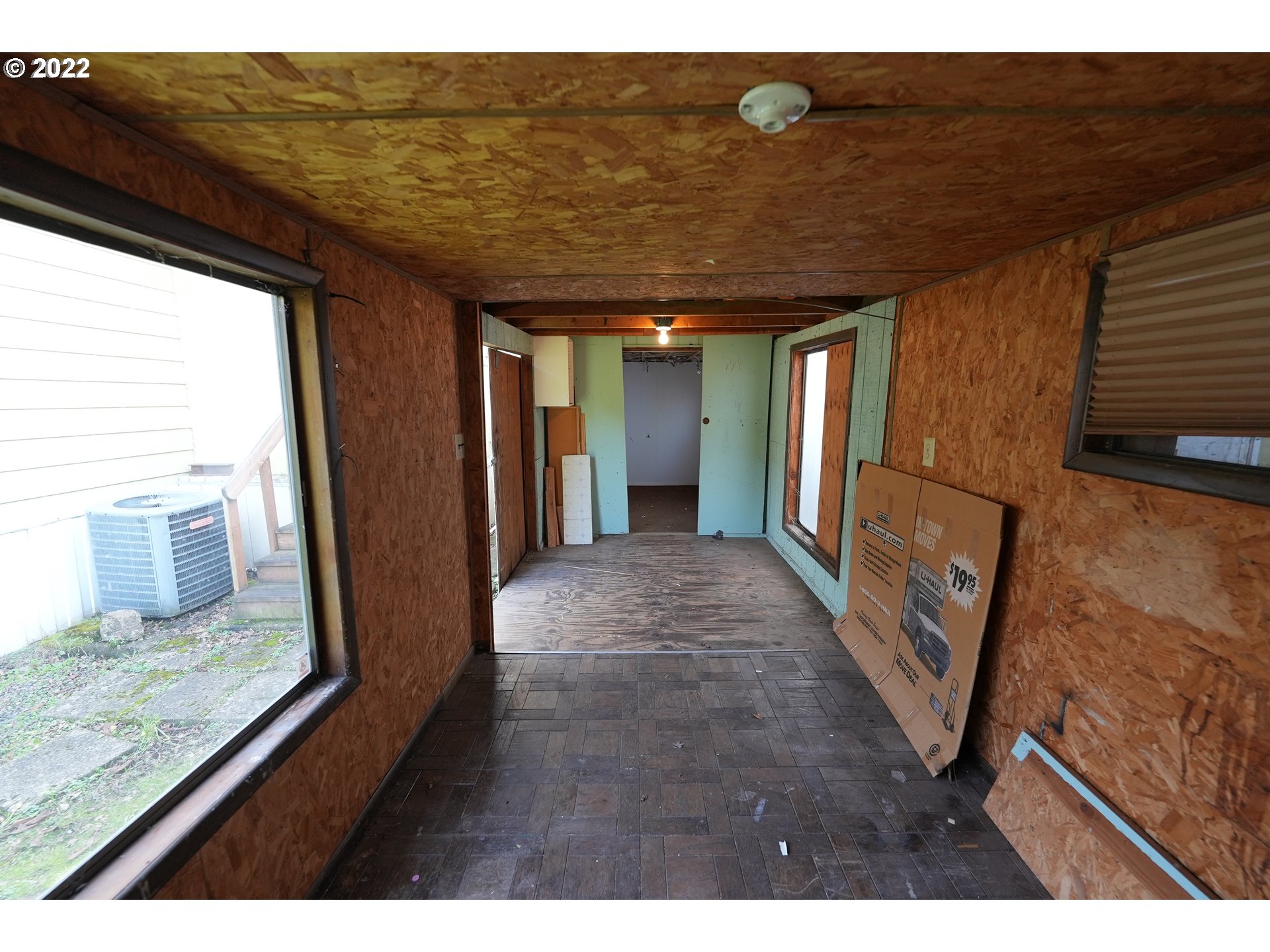 3530 Game Farm Road, Unit 11 Springfield, OR 97477 - Photo 19 of 27 a view of a hallway with wooden floor and seating space