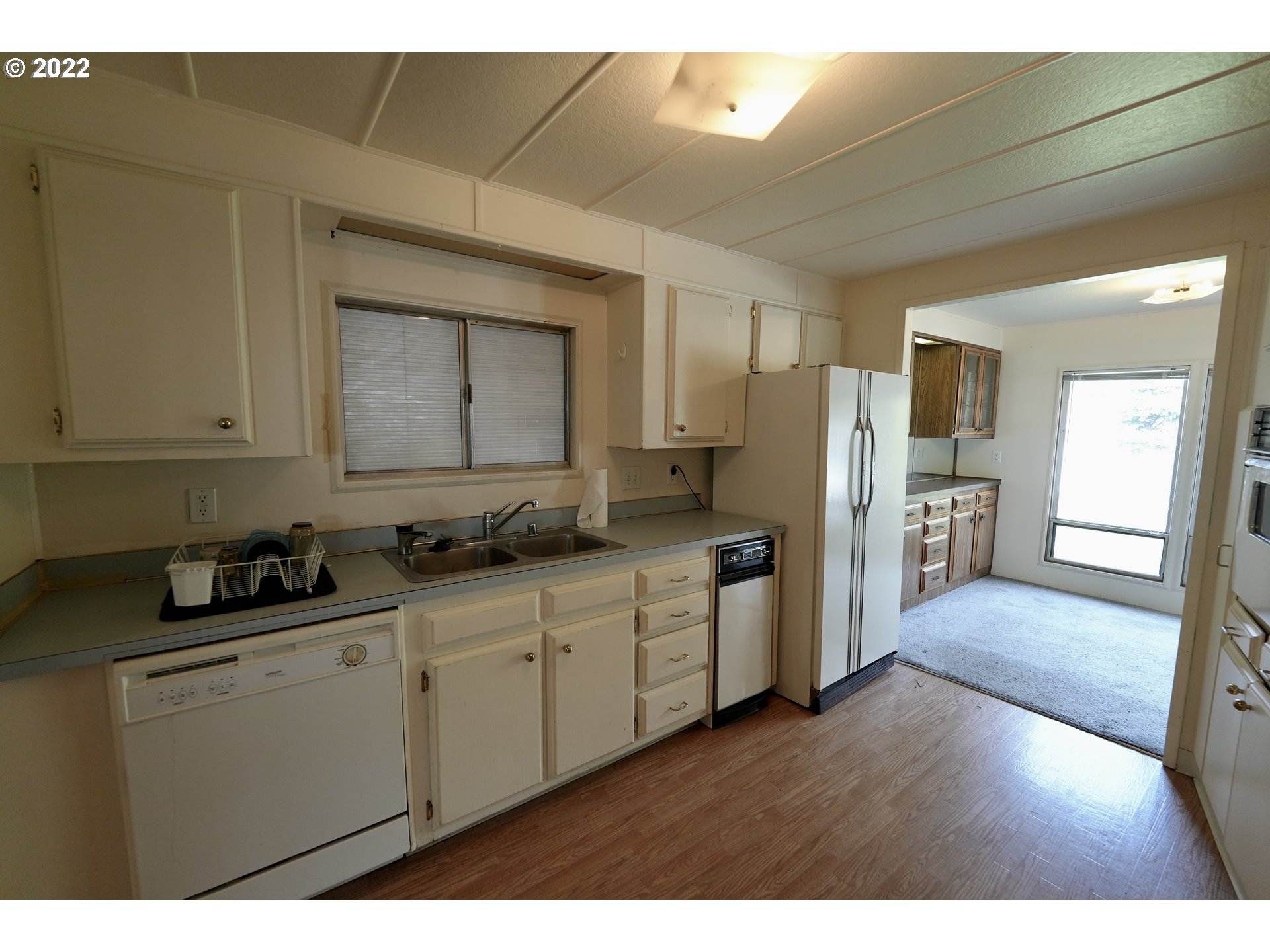 3530 Game Farm Road, Unit 11 Springfield, OR 97477 - Photo 7 of 27 a kitchen with cabinets and wooden floor