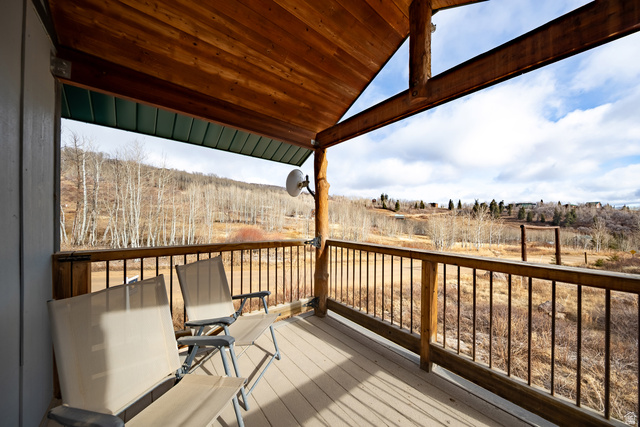 2029 West Tollgate Road Coalville, UT 84017 - Photo 17 of 36 Covered wood-finish deck with log columns, wood-finish ceiling, and metal railings