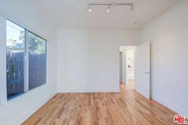 a view of an empty room and wooden floor