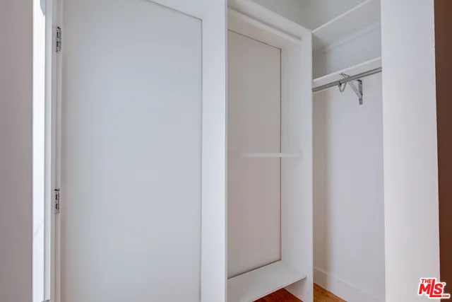 a view of an empty room and wooden floor