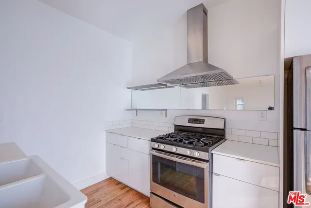 a stove top oven sitting inside of a kitchen