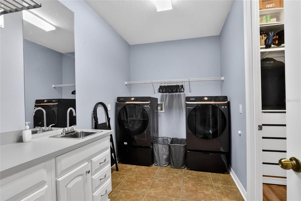 232 Magneta Loop Auburndale, FL 33823 - Photo 11 of 80 a kitchen with stainless steel appliances kitchen island granite countertop a refrigerator and a sink