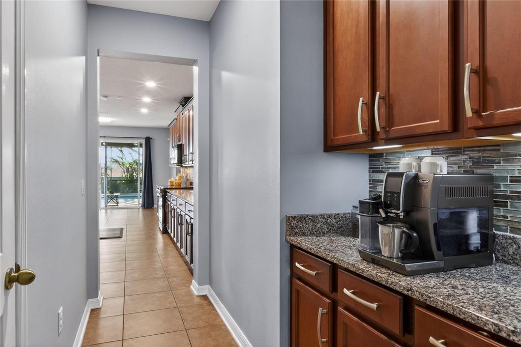 232 Magneta Loop Auburndale, FL 33823 - Photo 41 of 80 a kitchen with stainless steel appliances granite countertop a sink and cabinets