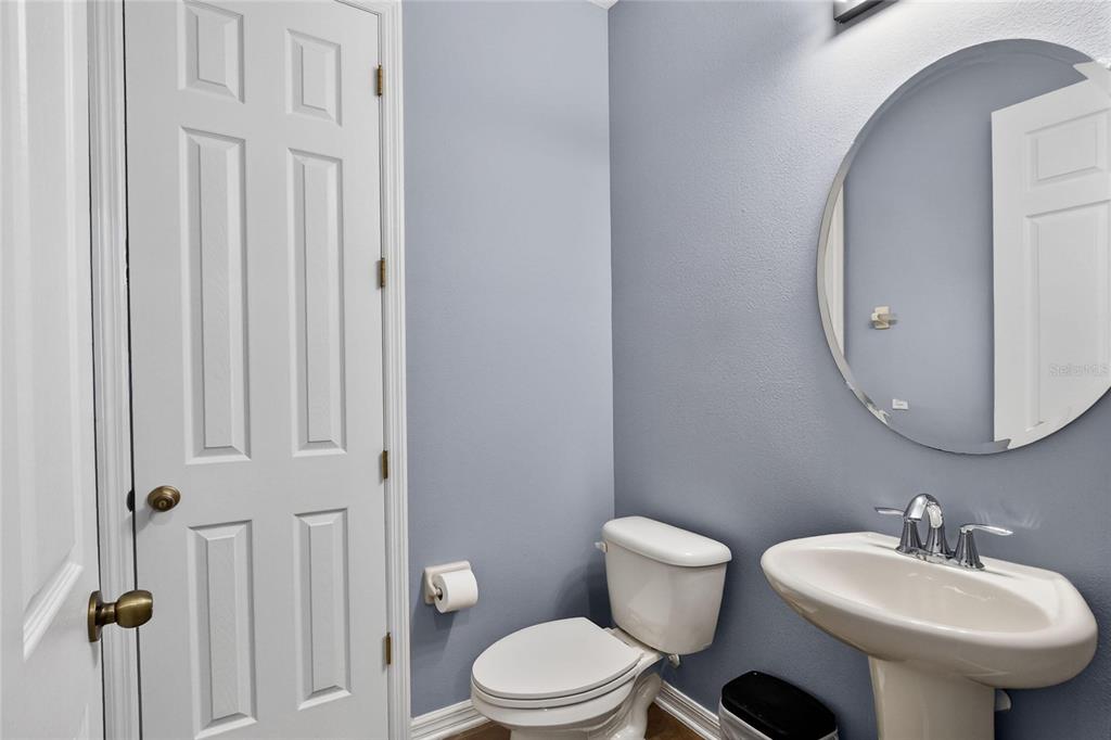232 Magneta Loop Auburndale, FL 33823 - Photo 42 of 80 a bathroom with a toilet a sink and mirror