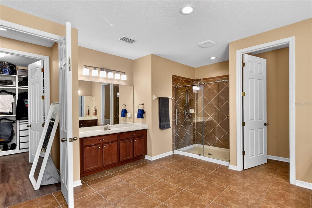 232 Magneta Loop Auburndale, FL 33823 - Photo 56 of 80 a bathroom with a tub sink shower and mirror