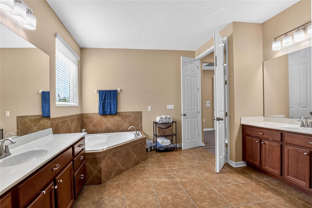 232 Magneta Loop Auburndale, FL 33823 - Photo 57 of 80 a spacious bedroom with a bed and a table in it
