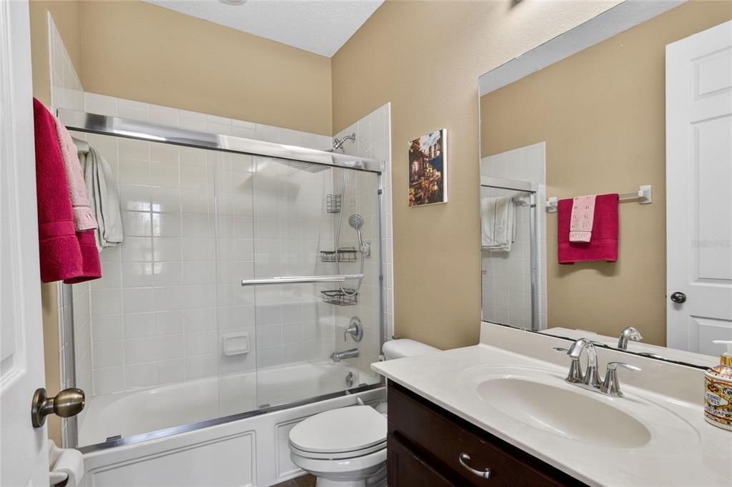 232 Magneta Loop Auburndale, FL 33823 - Photo 63 of 80 a bathroom with a sink vanity mirror and toilet